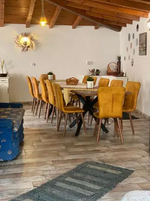 a dining room with a table and chairs at Къща за гости Casa Per Te село Огняново - село Марчево in Marchevo