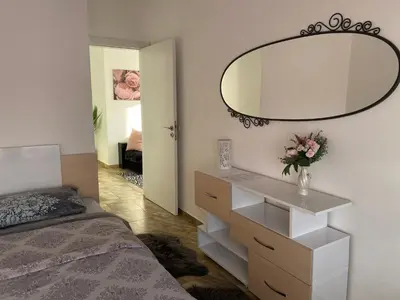 a bedroom with a white dresser and a mirror at Къща за гости Casa Per Te село Огняново - село Марчево in Marchevo