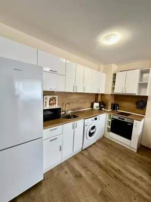 a kitchen with white cabinets and a sink and a dishwasher at CENTER Elegant Living in Sofia