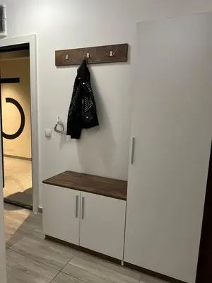 a white counter with a black bag hanging on a wall at CENTER Elegant Living in Sofia