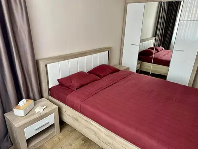 a bedroom with a red bed with a mirror at CENTER Elegant Living in Sofia