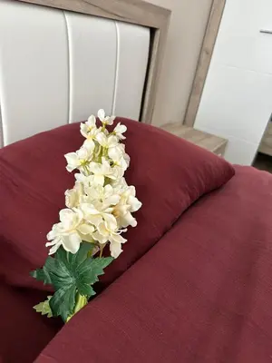a bouquet of white flowers sitting on top of a bed at CENTER Elegant Living in Sofia