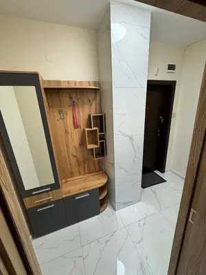 a bathroom with a large mirror and marble floor at Refurbished apartment in a quiet area in Sofia