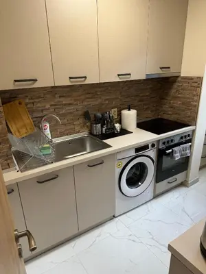 a kitchen with a sink and a washing machine at Refurbished apartment in a quiet area in Sofia