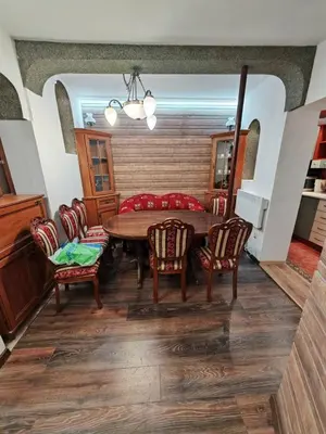 a dining room with a wooden table and chairs at Central 1-BR Apartment in Sofia