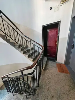 a set of stairs with a red door at Central 1-BR Apartment in Sofia