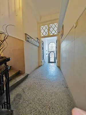 an empty hallway of a building with a window at Central 1-BR Apartment in Sofia