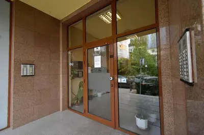 an entrance to an office building with glass doors at 19 Cozy Central Apartment with Balcony in Sofia