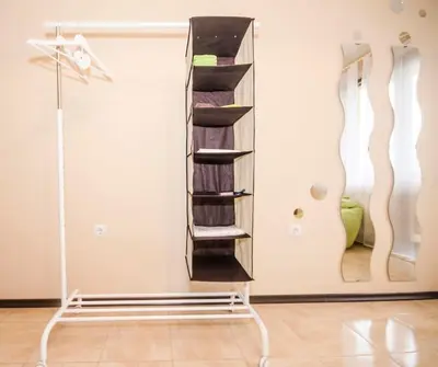 a shelf in the corner of a room with a closet at 19 Cozy Central Apartment with Balcony in Sofia