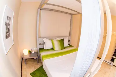 a bed in a small room with a mirror at 19 Cozy Central Apartment with Balcony in Sofia