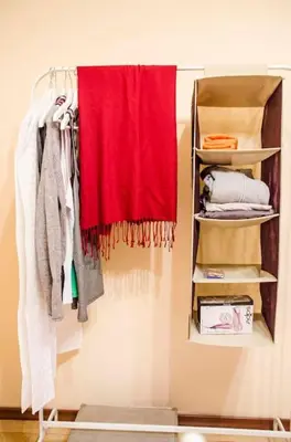 a closet with a red towel hanging on a wall at 23 Central 1 Bedroom Apartment with Balcony in Sofia
