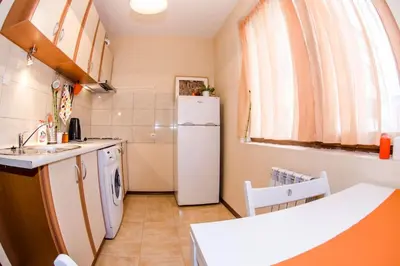 a kitchen with a white refrigerator and a sink at 23 Central 1 Bedroom Apartment with Balcony in Sofia