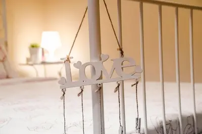 a crib with a sign that says love on it at 23 Central 1 Bedroom Apartment with Balcony in Sofia