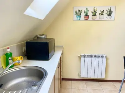 a bathroom with a sink and a tv on a counter at 35 Cozy Central 1 Bedroom Apartment with Balcony in Sofia