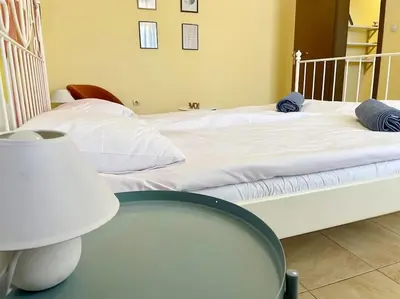 a bedroom with a white bed and a table at 35 Cozy Central 1 Bedroom Apartment with Balcony in Sofia