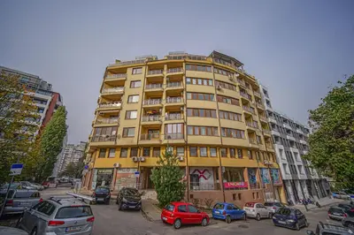 a tall building with cars parked in front of it at 35 Cozy Central 1 Bedroom Apartment with Balcony in Sofia