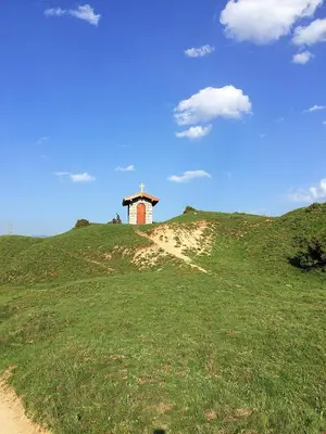 a chapel on top of a hill with a blue sky at Monastery Apartment C39 in Bansko