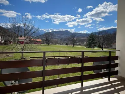 a balcony with a view of a field and mountains at Вила и тенис комплекс ,,Синьото