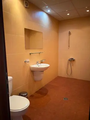 a bathroom with a toilet and a sink at Вила и тенис комплекс ,,Синьото