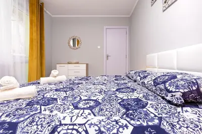 a bedroom with a large blue and white bed at Central apt 'SELIN' Walking distance to center in Plovdiv