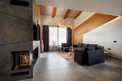 a living room with a couch and a fireplace at Local Stay Villas in Bansko