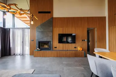 a living room with a fireplace and a tv at Local Stay Villas in Bansko