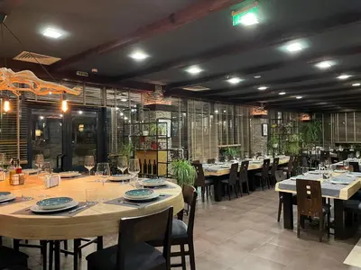 a large dining room with tables and chairs at Local Stay Villas in Bansko