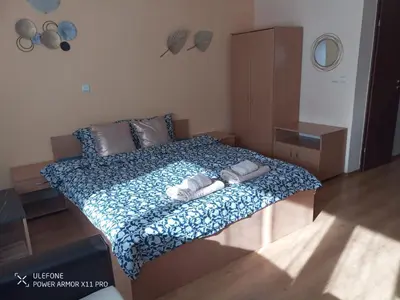 a bedroom with a bed with two towels on it at studio royal park bansko in Bansko