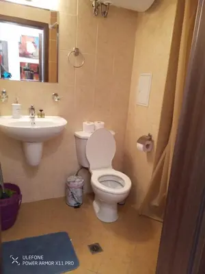 a bathroom with a toilet and a sink at studio royal park bansko in Bansko