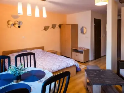 a bedroom with a bed and a table and chairs at studio royal park bansko in Bansko