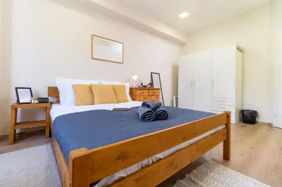 a bedroom with a large bed with a blue blanket at Chic Urban Getaway in City Center by Flat Mаnager in Plovdiv