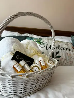 a basket filled with bottles of wine on a bed at Casa Rea - Comfortable Stay with Free Parking in Sofia