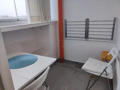a room with a desk and a chair and a window at Апартамент Pavlin in Plovdiv
