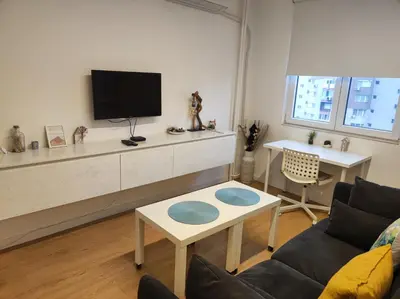 a living room with a couch and a tv at Апартамент Pavlin in Plovdiv