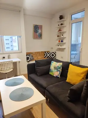a living room with a couch and a table at Апартамент Pavlin in Plovdiv