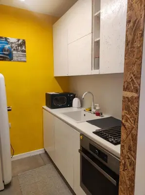 a kitchen with a sink and a stove top oven at Апартамент Pavlin in Plovdiv