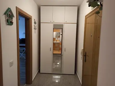 a hallway with a white cabinet and a door at Sunny Hill Sandanski in Sandanski