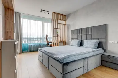 a bedroom with a large bed and a large window at Luxury 2 BDRM Getaway and Free Parking in Sofia