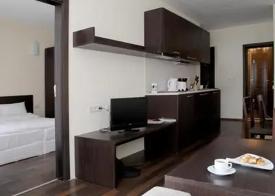 a room with a desk with a computer and a bed at Ski Lift Apartment in Bansko in Bansko