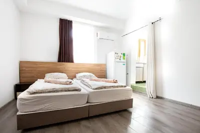 a bedroom with a large bed with a wooden headboard at Nova Guesthouse - Private En-Suite Rooms I Sofia Center I Self Check-In in Sofia