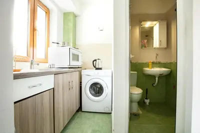 a bathroom with a washing machine and a sink at Nova Guesthouse - Private En-Suite Rooms I Sofia Center I Self Check-In in Sofia