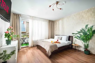 a bedroom with a bed with a tray of fruit on it at Spacious and relaxing in Sofia