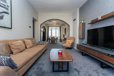 a living room with a couch and a flat screen tv at Urban Elegance Apartment in Sofia