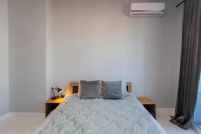 a bedroom with a bed and a nightstand and a bed sidx sidx sidx sidx at Urban Elegance Apartment in Sofia