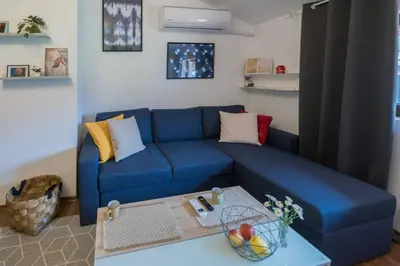 a blue couch in a living room with a table at Ski Nomad Bansko in Bansko