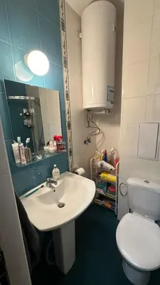 a bathroom with a sink and a toilet and a mirror at Ski Nomad Bansko in Bansko