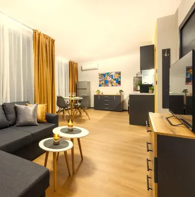 a living room with a couch and a tv at Best Guest 2 Apartments in Plovdiv