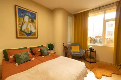 a bedroom with a large bed and a window at ArtE Vitosha Blvd in Sofia