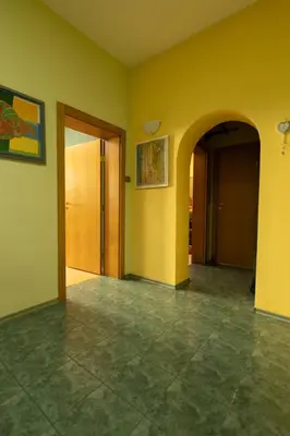 an empty room with yellow walls and a tile floor at ArtE Vitosha Blvd in Sofia