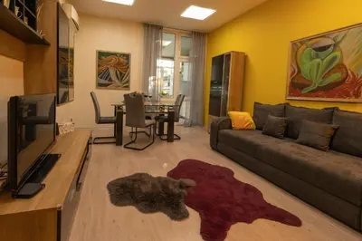 a living room with a couch and a table at ArtE Vitosha Blvd in Sofia